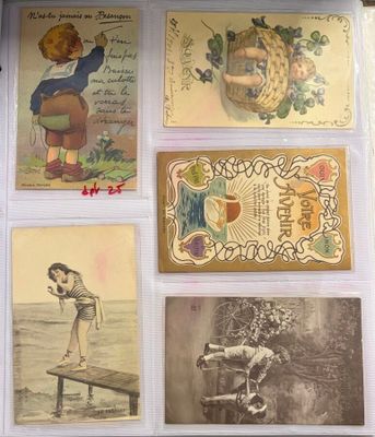 many old postcards of children on display in a display case