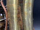 a close up view of a brass saxophone with a chain around it