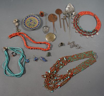 several necklaces and bracelets are arranged on a gray surface