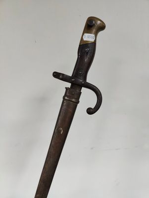 a close up of a knife on a table with a white background
