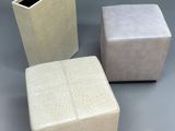 three square stools with a planter in the middle of them
