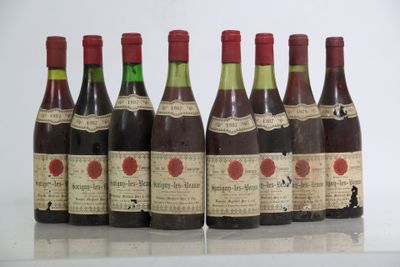 six bottles of wine are lined up in a row on a table