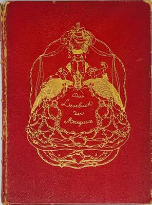 an old red book with a gold design on the cover