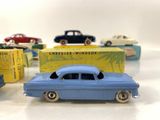 several toy cars are lined up in a row on a table