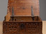 an old wooden box with two handles on a table