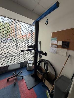 an image of a gym room with equipment and a window