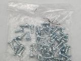 a bunch of screws and nuts in a bag on a table