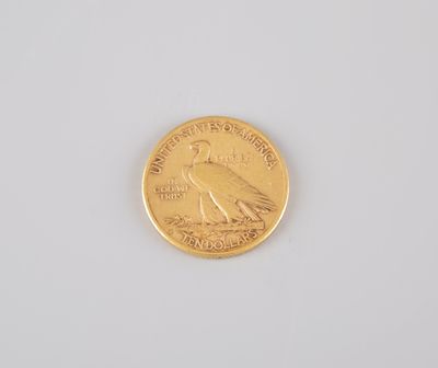 a close up of a gold coin on a white surface