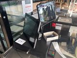 a laptop computer sitting on top of a table in front of a glass case