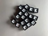 a lot of black and white boxes with green eyes on them