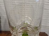 a glass vase sitting on top of a wooden table