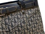 the back view of a brown and black purse with a black handle