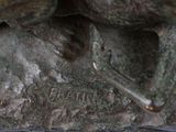 a statue of a horse that is sitting on a rock