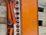 an orange box with a bunch of pipes inside of it