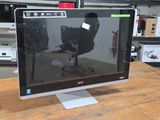 a computer monitor sitting on top of a wooden table