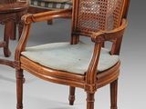 two chairs and a table in a room with a striped couch