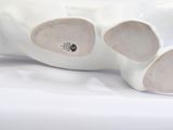 pair of white ceramic shoes on a white surface