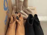 three pairs of shoes that are sitting on top of a cardboard box