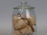 a glass jar with onions in it on a table
