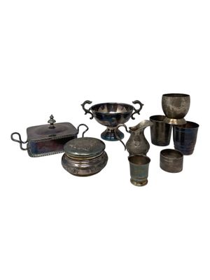 a lot of silver items that are sitting on a table