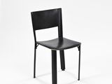 a black chair that is sitting on a white surface