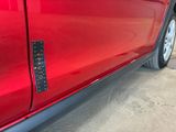 a close up of a red car with a sticker on it