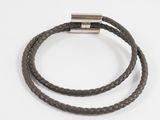 a close up of a brown leather bracelet with a metal clasp