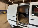 a white van with its doors open in a garage