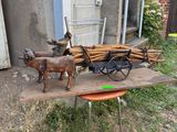 a wooden cart with a horse and a dog on it