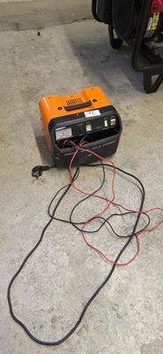 an orange and black radio sitting on the ground