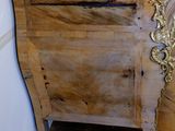 a wooden chest with a marble top on a hard wood floor