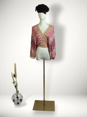 an image of a mannequin with a pink blouse and black hat