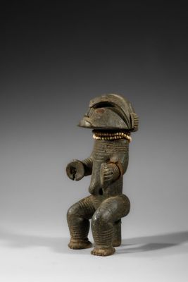 an image of a statue of a man sitting on a stool
