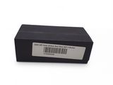 a black box with a barcode on it sitting on a white surface