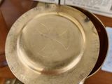 a gold plate sitting on top of a glass table