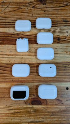 an image of a wooden table topped with white electronic gadgets