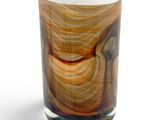a close up of a glass with a brown swirl on it
