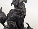 a statue of a dog sitting on top of a table