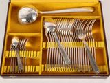 a yellow box with silverware in it on a white surface
