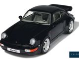 a black toy car that is sitting on a white surface