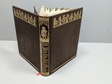 an old book sitting on top of a white table