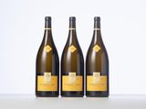 three bottles of wine sitting on top of a table next to each other