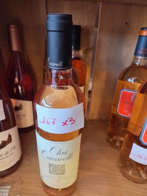 many bottles of wine on a shelf with labels on them