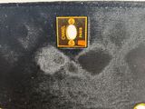 a close up of a black purse with gold chains on it
