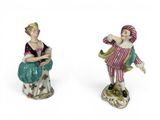 pair of porcelain figurines of a man and a woman