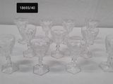 six clear glass wine glasses sitting on top of a white table