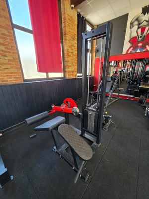 a gym with a bench, weights, and other equipment in the room