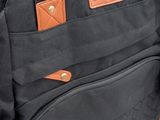 a black bag that is sitting on top of a bench