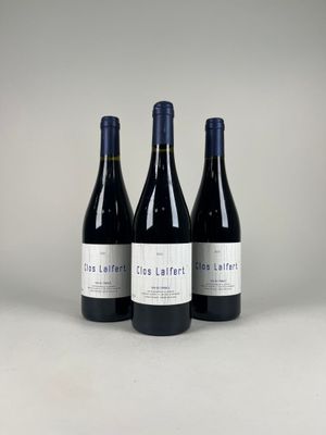 three bottles of wine sitting on top of a table