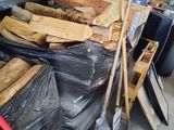 a large pile of wood and tools in a garage